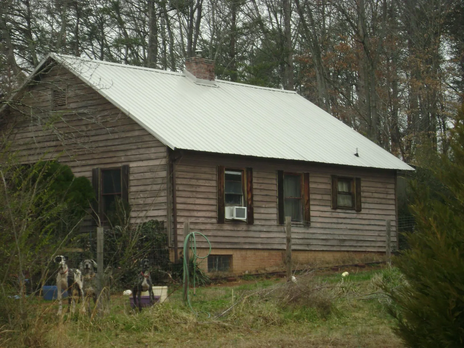 White metal roof on an old wood sided farmhouse, from a Metal Roof Installation job in Glade Valley